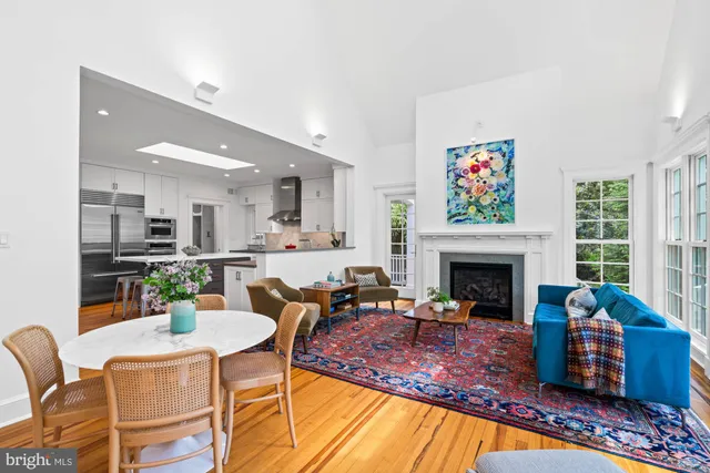 a living room with furniture a fireplace and a table