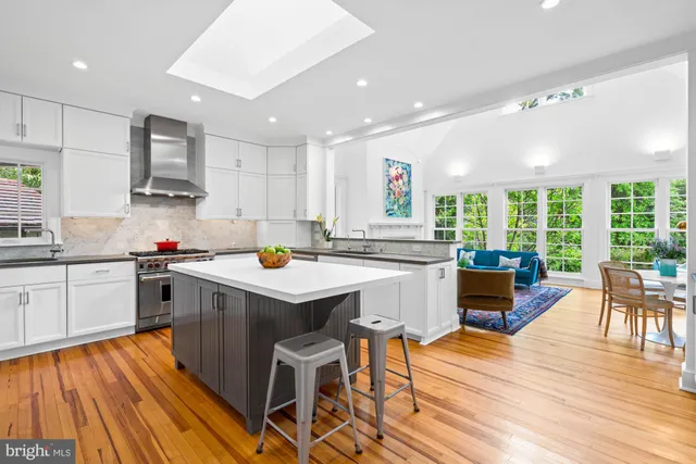 a kitchen with stainless steel appliances granite countertop sink stove top oven and cabinets