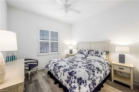 a bedroom with a large bed and a lamp on table