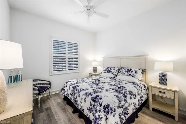 a bedroom with a large bed and a lamp on table