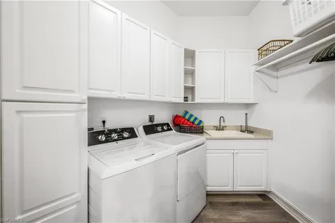 a utility room with sink dryer and washer