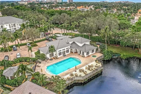 an aerial view of residential houses with outdoor space and lake view