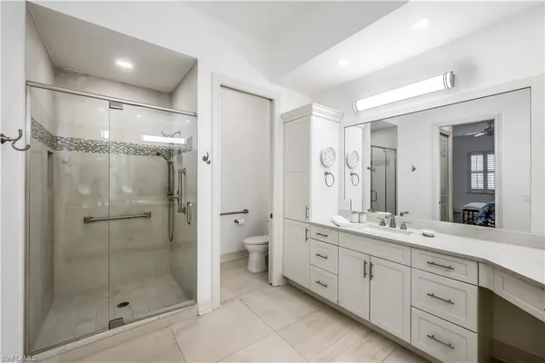 a spacious bathroom with a shower sink mirror and