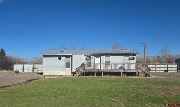 a view of a house with a backyard