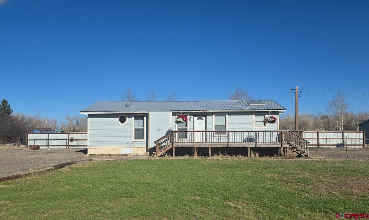 a view of a house with a backyard