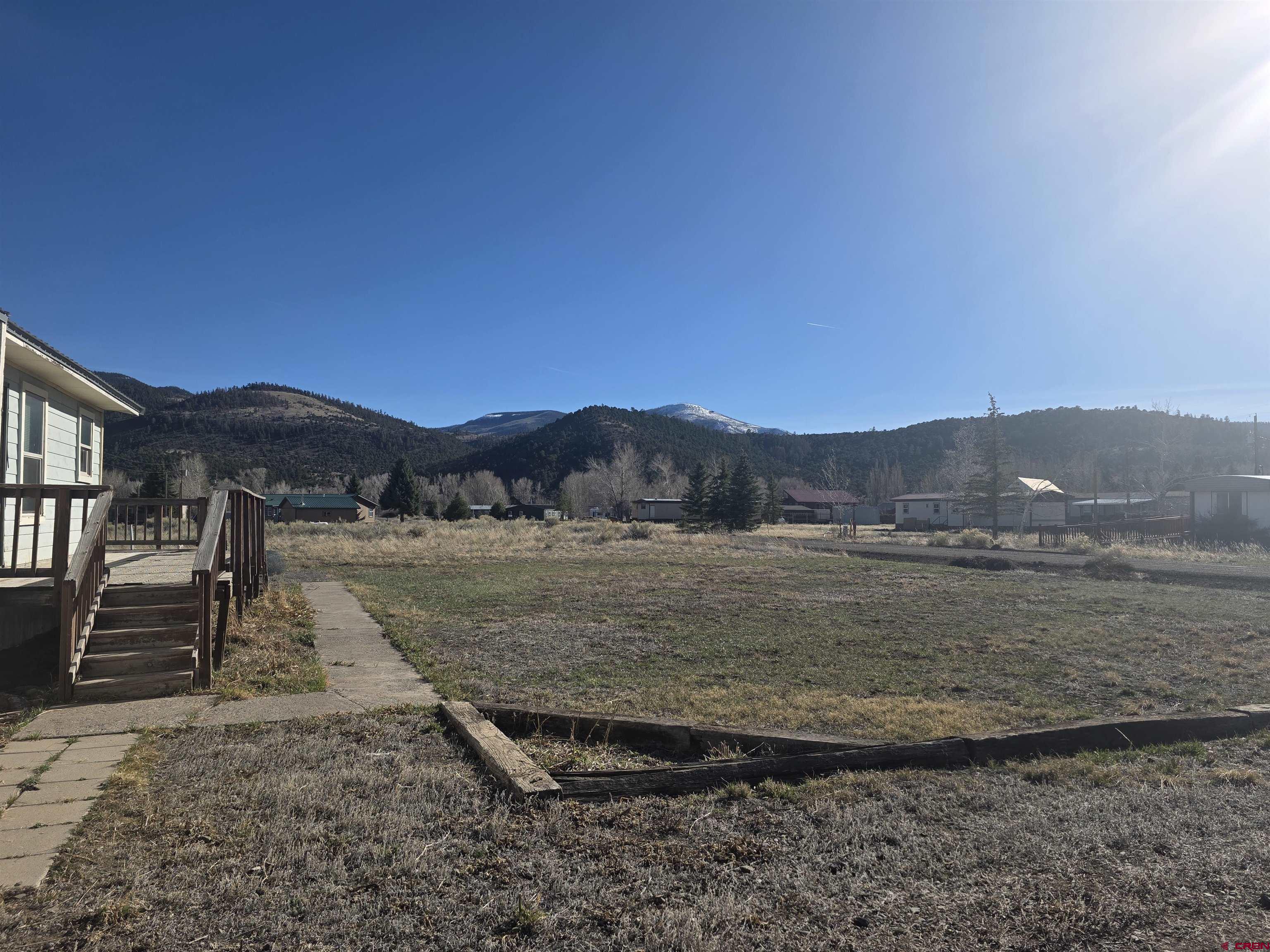 232D Arapahoe Road South Fork, CO 81154 - Photo 19 of 23 a view of a dry yard with trees