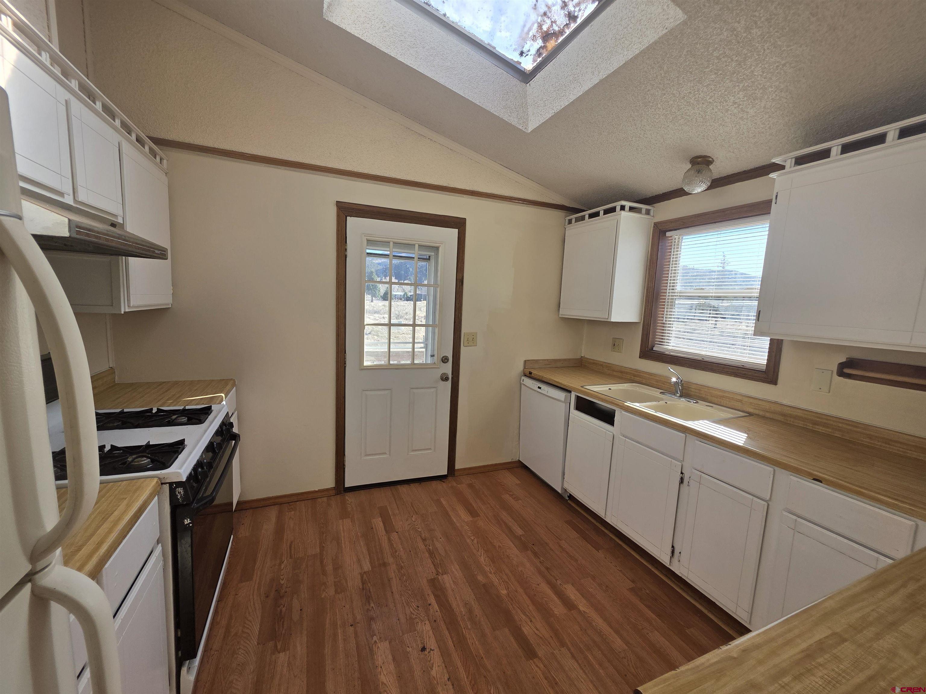 232D Arapahoe Road South Fork, CO 81154 - Photo 5 of 23 a kitchen with stainless steel appliances a sink cabinets and wooden floor