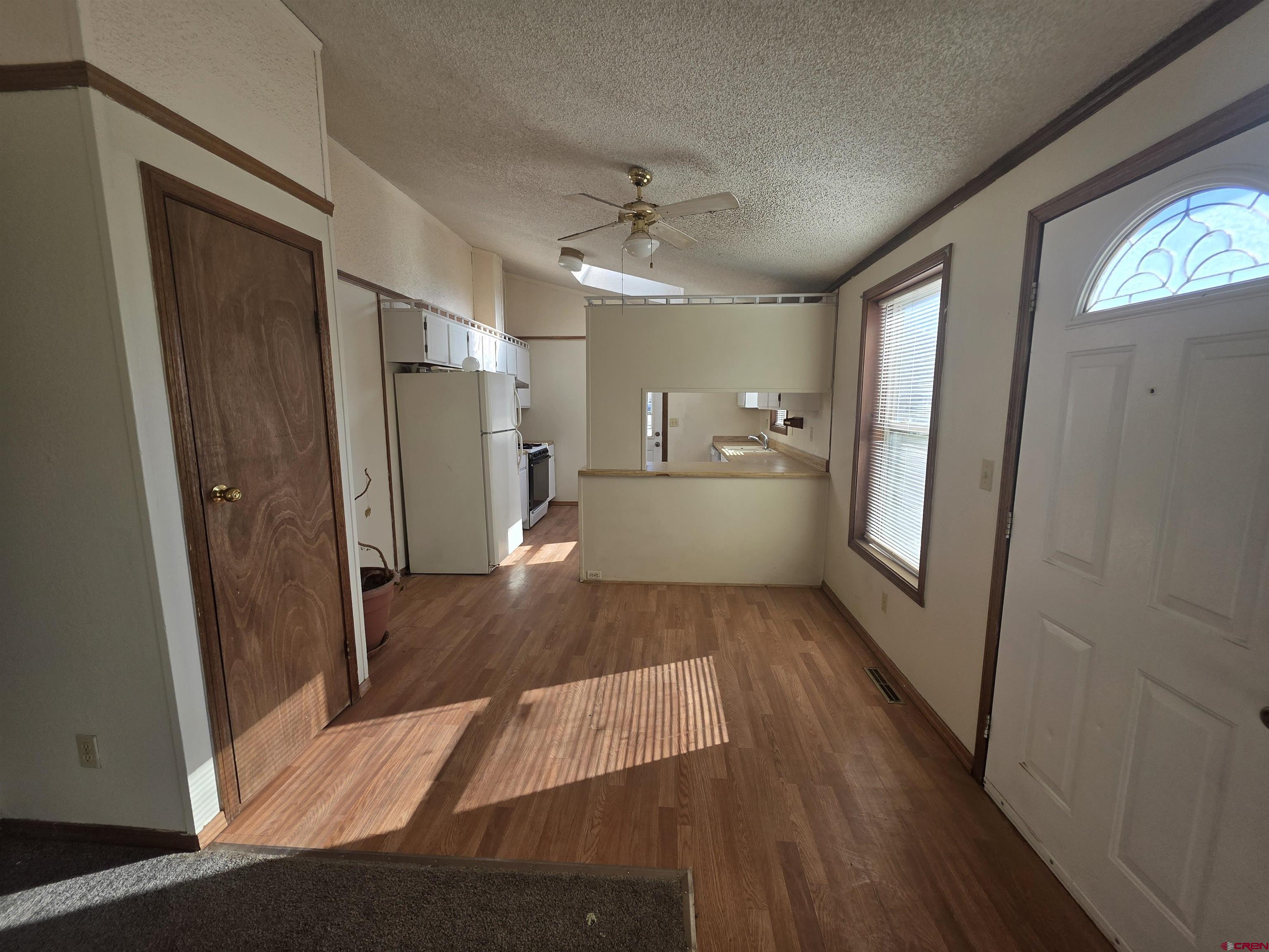 232D Arapahoe Road South Fork, CO 81154 - Photo 6 of 23 a view of a hallway with wooden floor and a living room