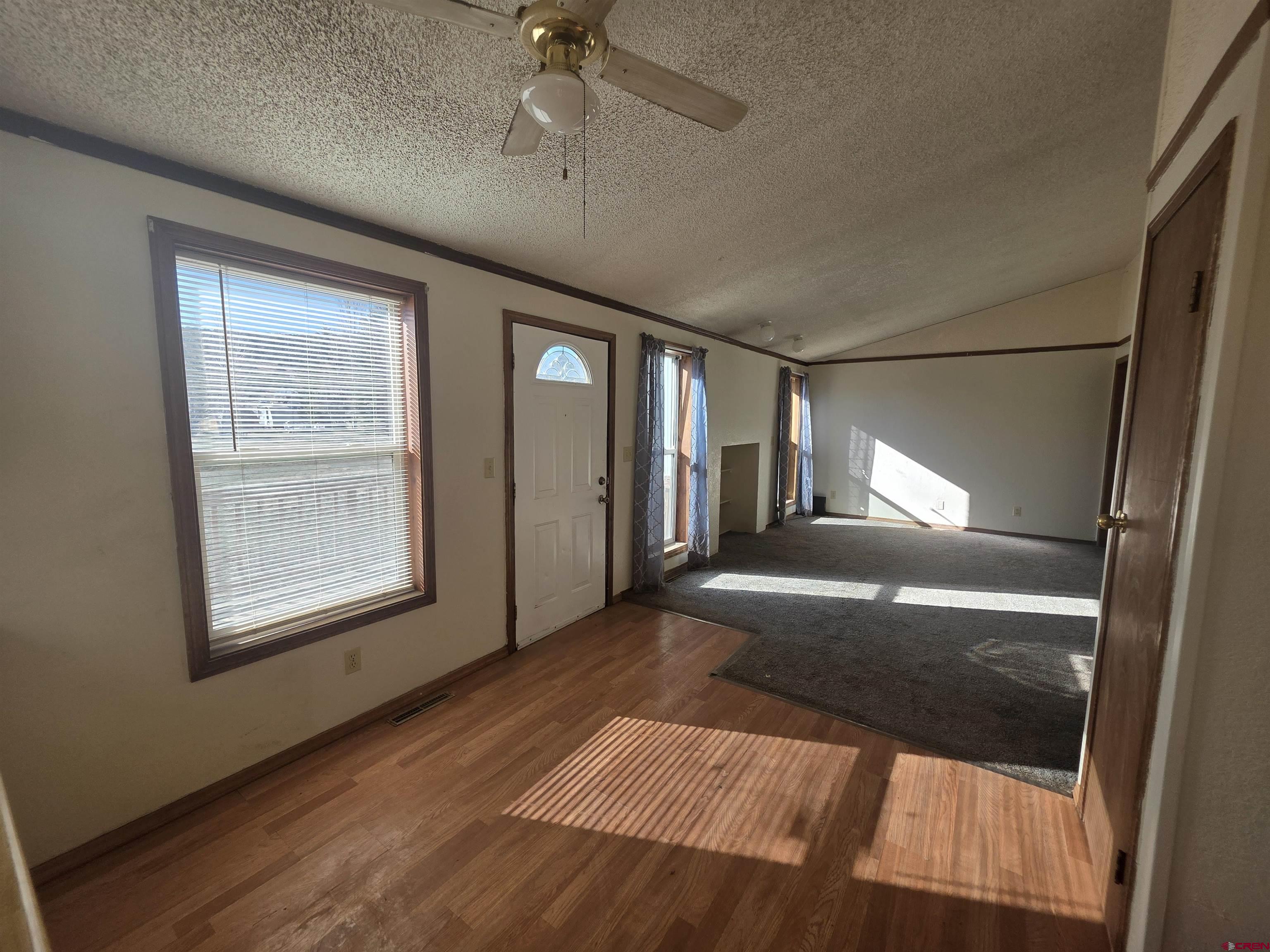 232D Arapahoe Road South Fork, CO 81154 - Photo 8 of 23 a view of empty room with wooden floor and fan