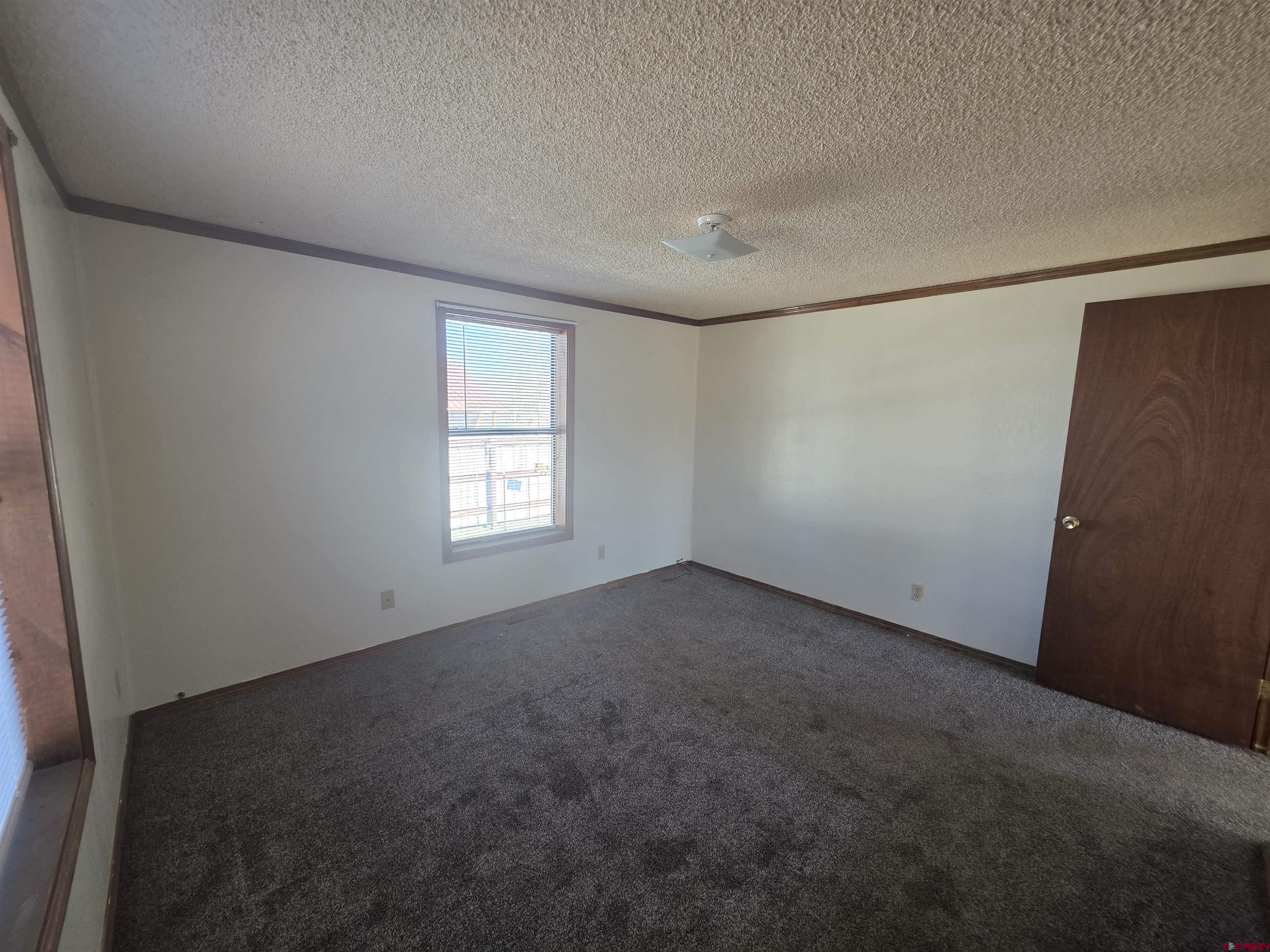 232D Arapahoe Road South Fork, CO 81154 - Photo 10 of 23 an empty room with a empty space and windows