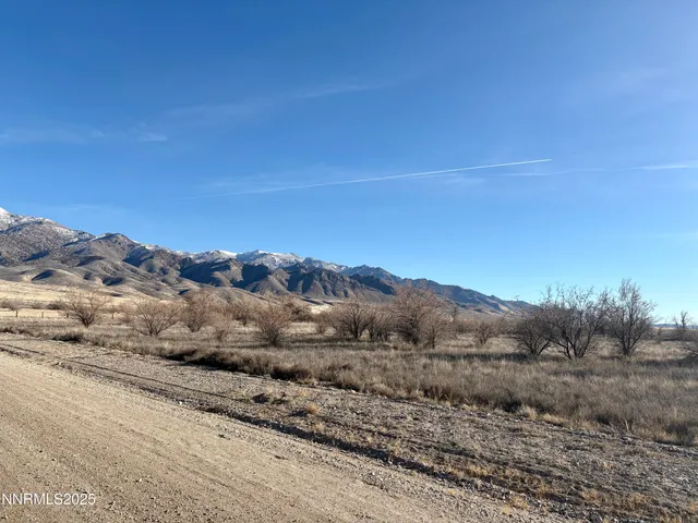 a view of a large mountain with mountains in the background