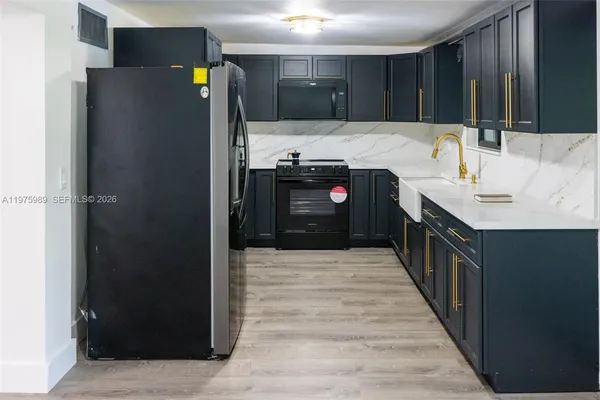 a kitchen with a stove and a microwave