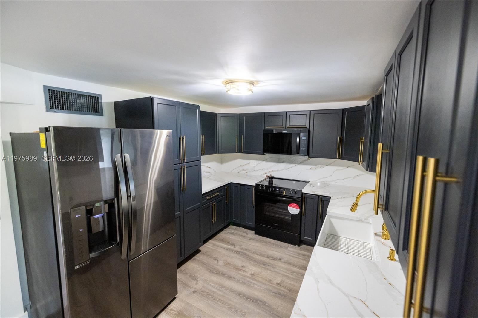 3401 Southwest 17th Street, Unit 3401 Miami, FL 33145 - Photo 20 of 69 a kitchen with stainless steel appliances granite countertop a refrigerator and a stove