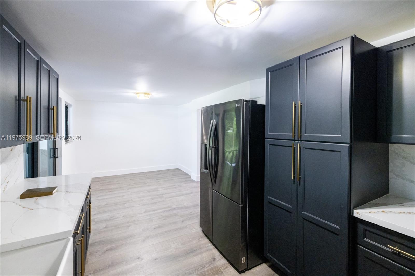 3401 Southwest 17th Street, Unit 3401 Miami, FL 33145 - Photo 22 of 69 a metallic refrigerator freezer sitting in a kitchen