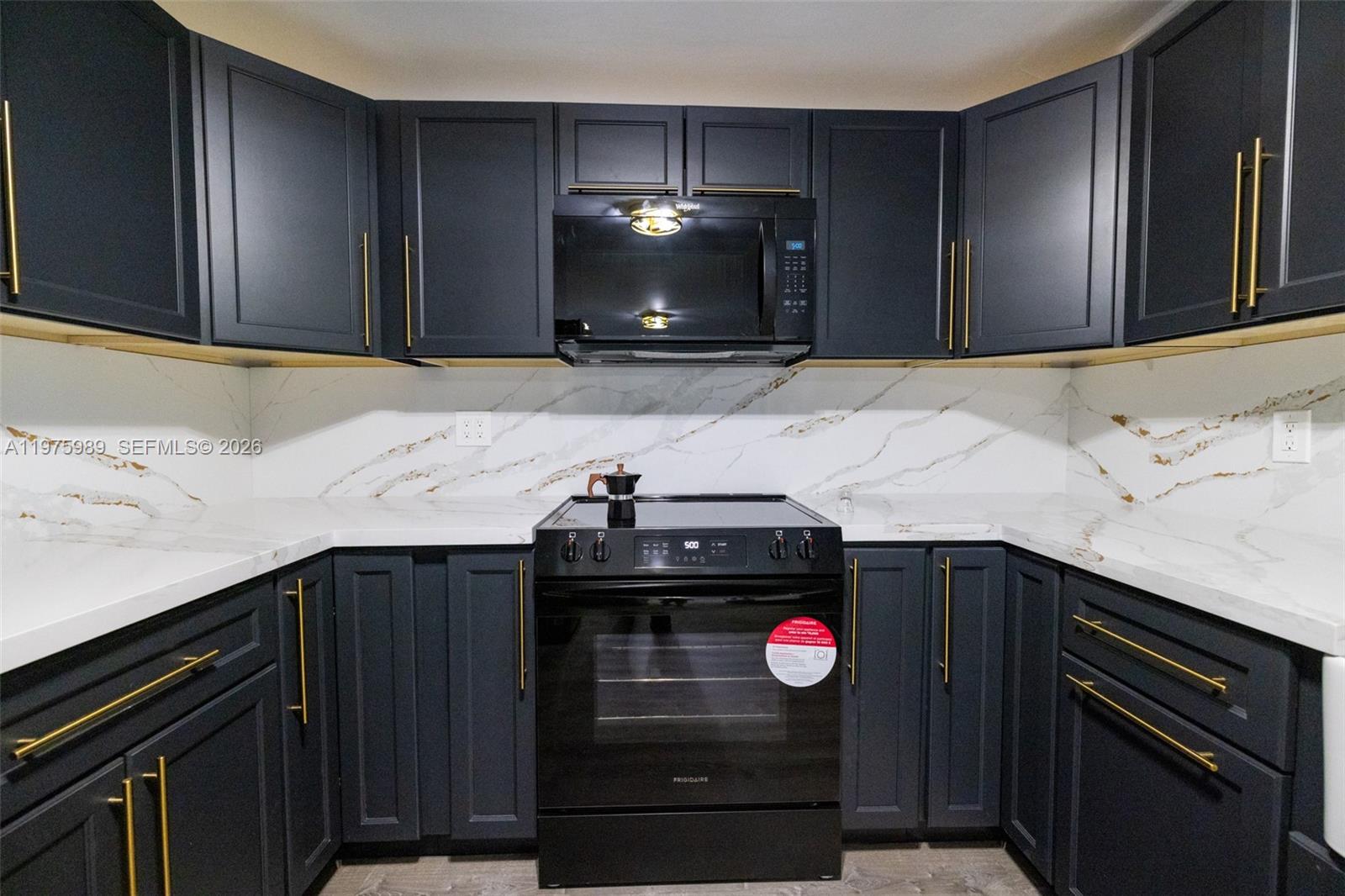 3401 Southwest 17th Street, Unit 3401 Miami, FL 33145 - Photo 24 of 69 a kitchen with a stove and a microwave