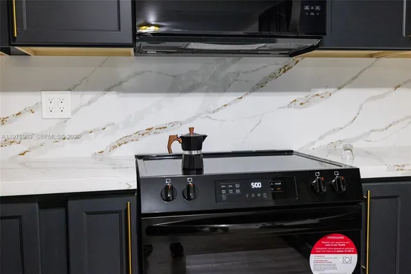 an empty room with wooden floor and a ceiling fan