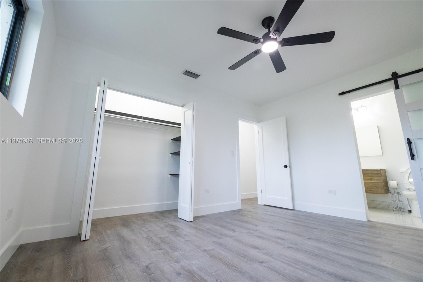 3401 Southwest 17th Street, Unit 3401 Miami, FL 33145 - Photo 36 of 69 an empty room with wooden floor and a ceiling fan