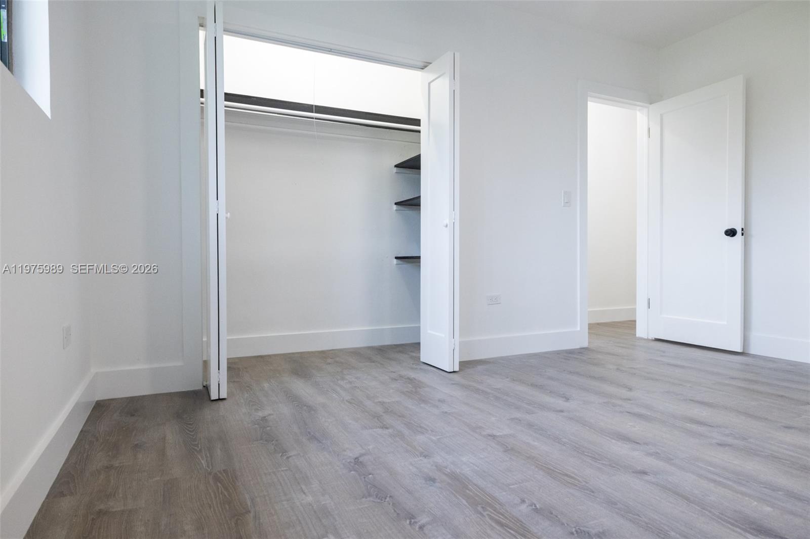 3401 Southwest 17th Street, Unit 3401 Miami, FL 33145 - Photo 37 of 69 a view of an empty room with wooden floor and closet