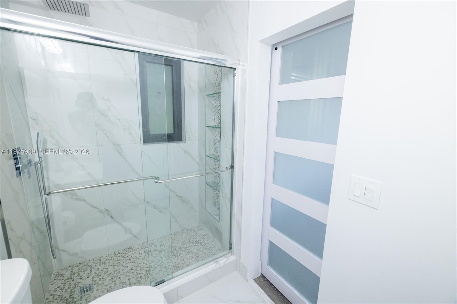 3401 Southwest 17th Street, Unit 3401 Miami, FL 33145 - Photo 42 of 69 a bathroom with a shower and a toilet