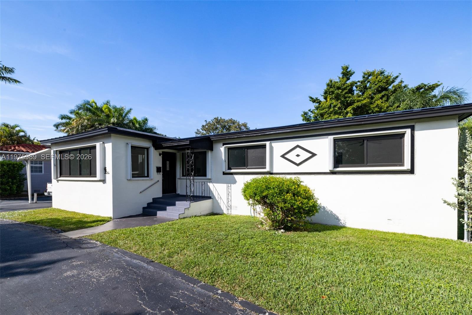 3401 Southwest 17th Street, Unit 3401 Miami, FL 33145 - Photo 5 of 69 a front view of a house with a yard and potted plants