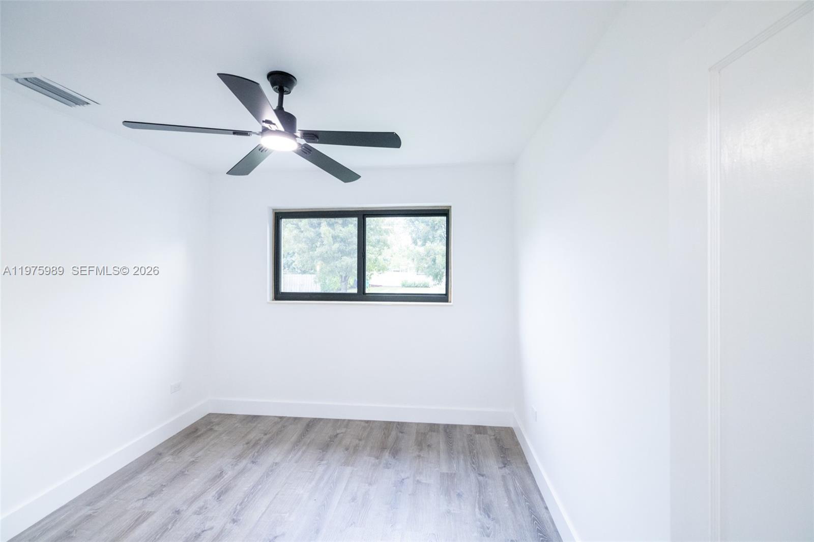 3401 Southwest 17th Street, Unit 3401 Miami, FL 33145 - Photo 52 of 69 an empty room with a window and a ceiling fan