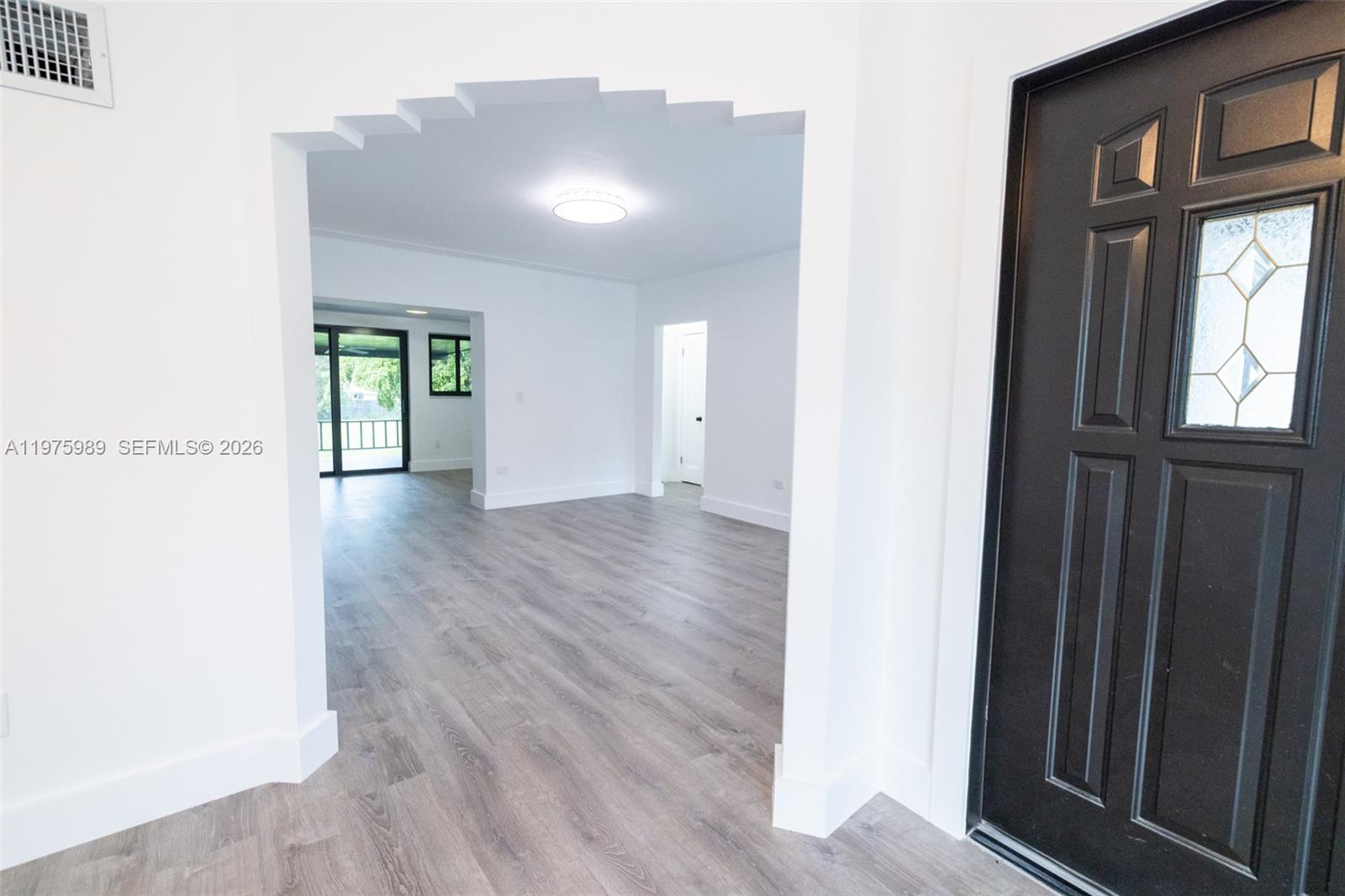 3401 Southwest 17th Street, Unit 3401 Miami, FL 33145 - Photo 59 of 69 a view of an empty room with wooden floor and a window