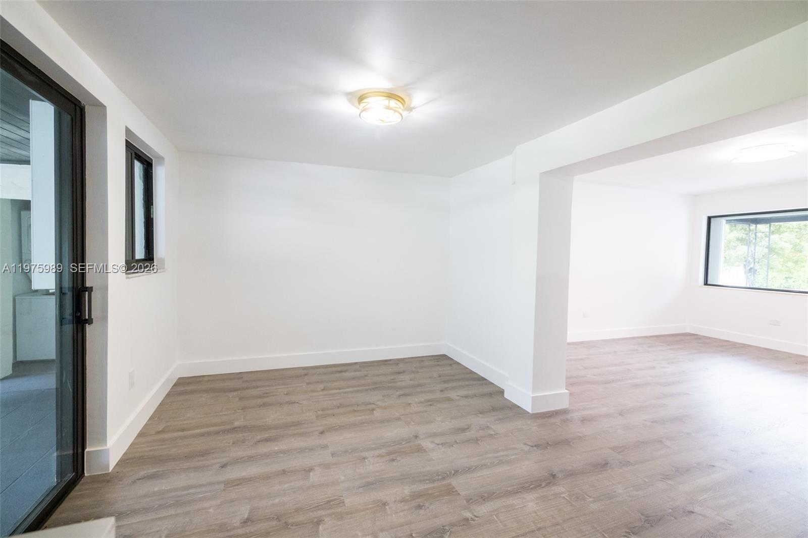 3401 Southwest 17th Street, Unit 3401 Miami, FL 33145 - Photo 64 of 69 an empty room with wooden floor and windows