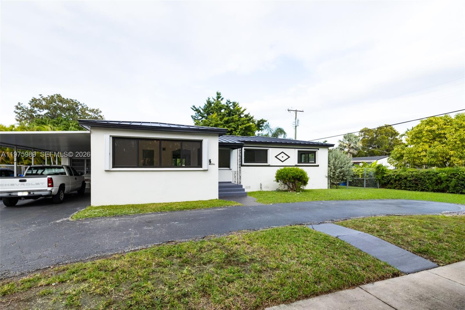 3401 Southwest 17th Street, Unit 3401 Miami, FL 33145 - Photo 8 of 69 a view of a house with a yard and potted plants