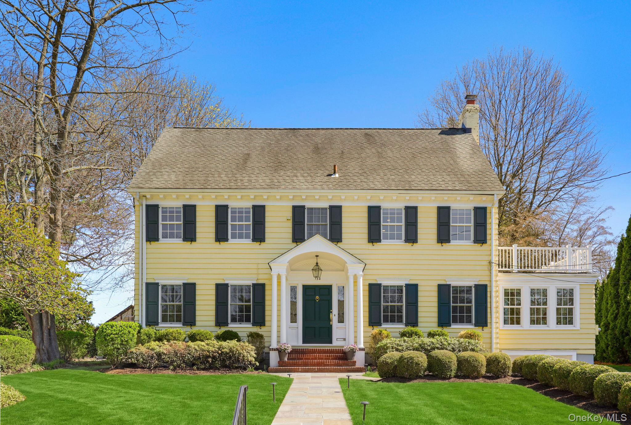 134 Brewster Road Scarsdale, NY 10583 - Photo 1 of 37 front view of a house with a yard
