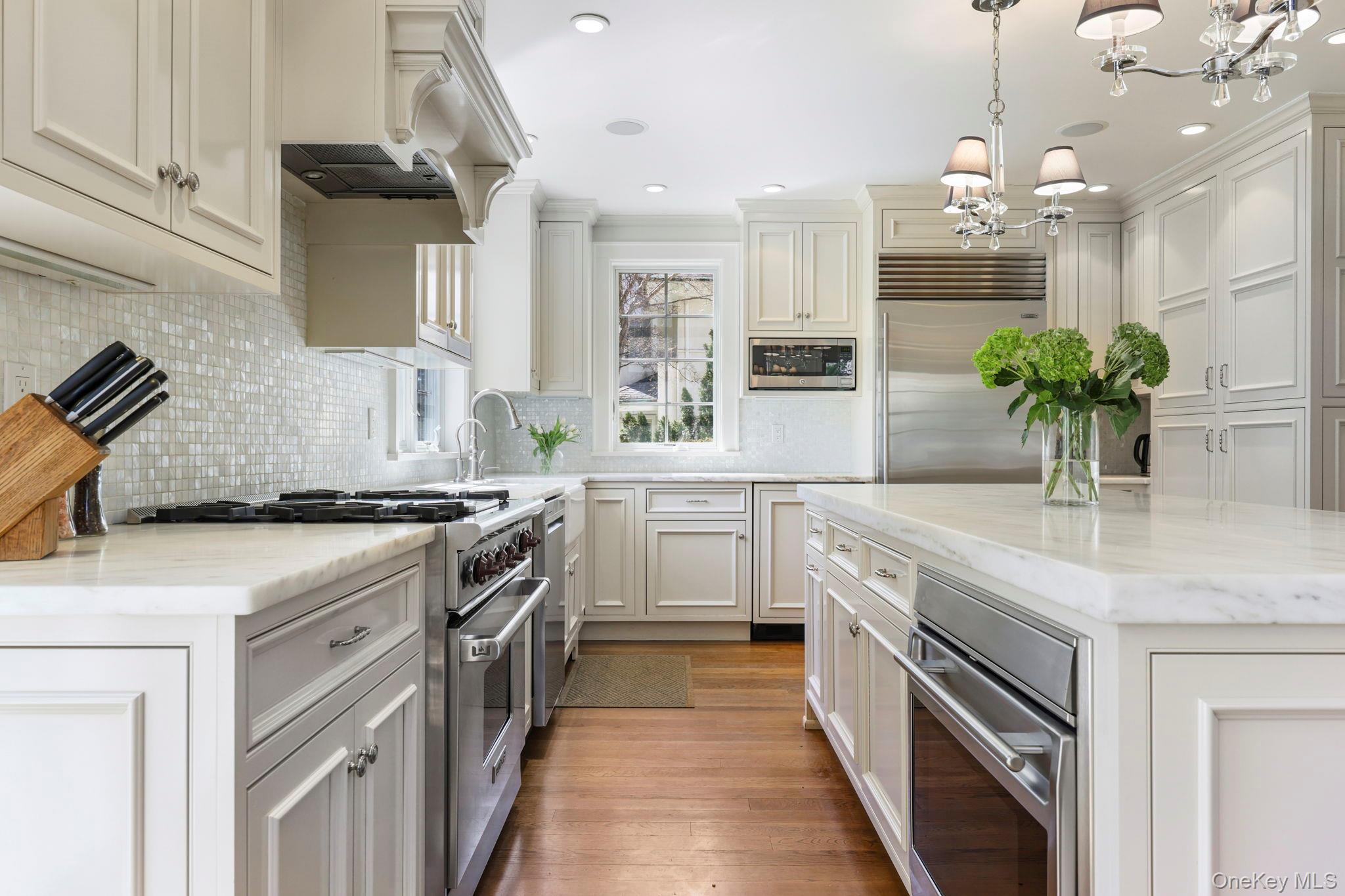 134 Brewster Road Scarsdale, NY 10583 - Photo 13 of 37 a kitchen with a sink stove and cabinets