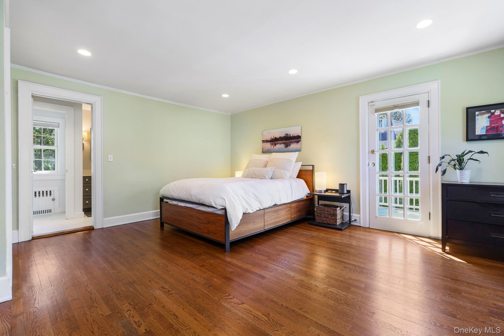 134 Brewster Road Scarsdale, NY 10583 - Photo 17 of 37 a bedroom with a bed and wooden floor