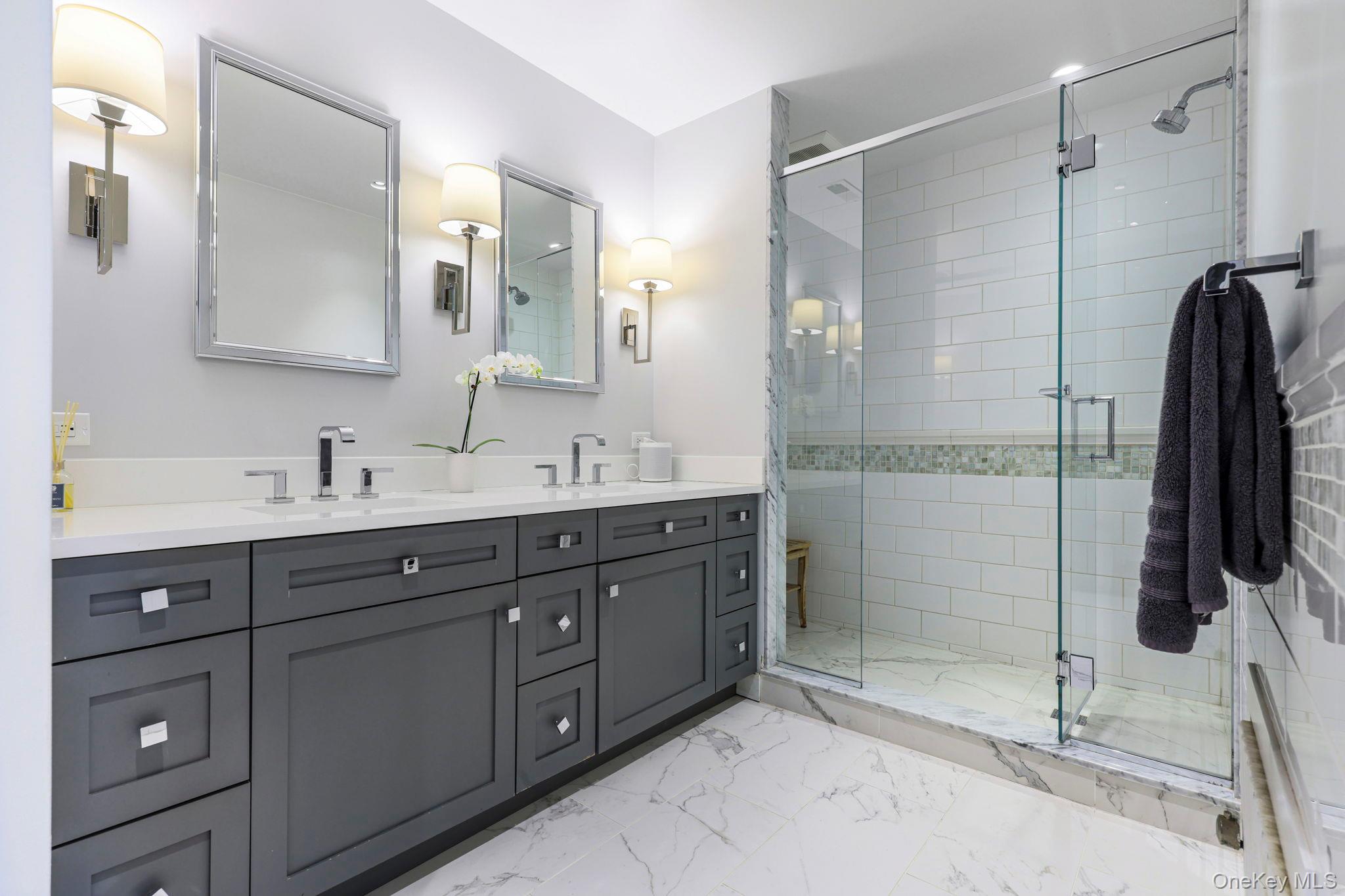 134 Brewster Road Scarsdale, NY 10583 - Photo 18 of 37 a bathroom with a double vanity sink and mirror