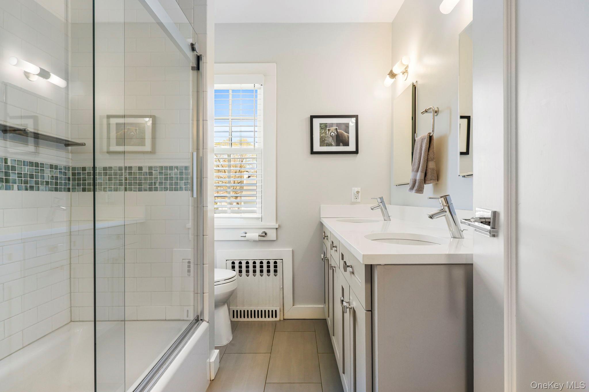134 Brewster Road Scarsdale, NY 10583 - Photo 20 of 37 a bathroom with a sink a toilet and shower