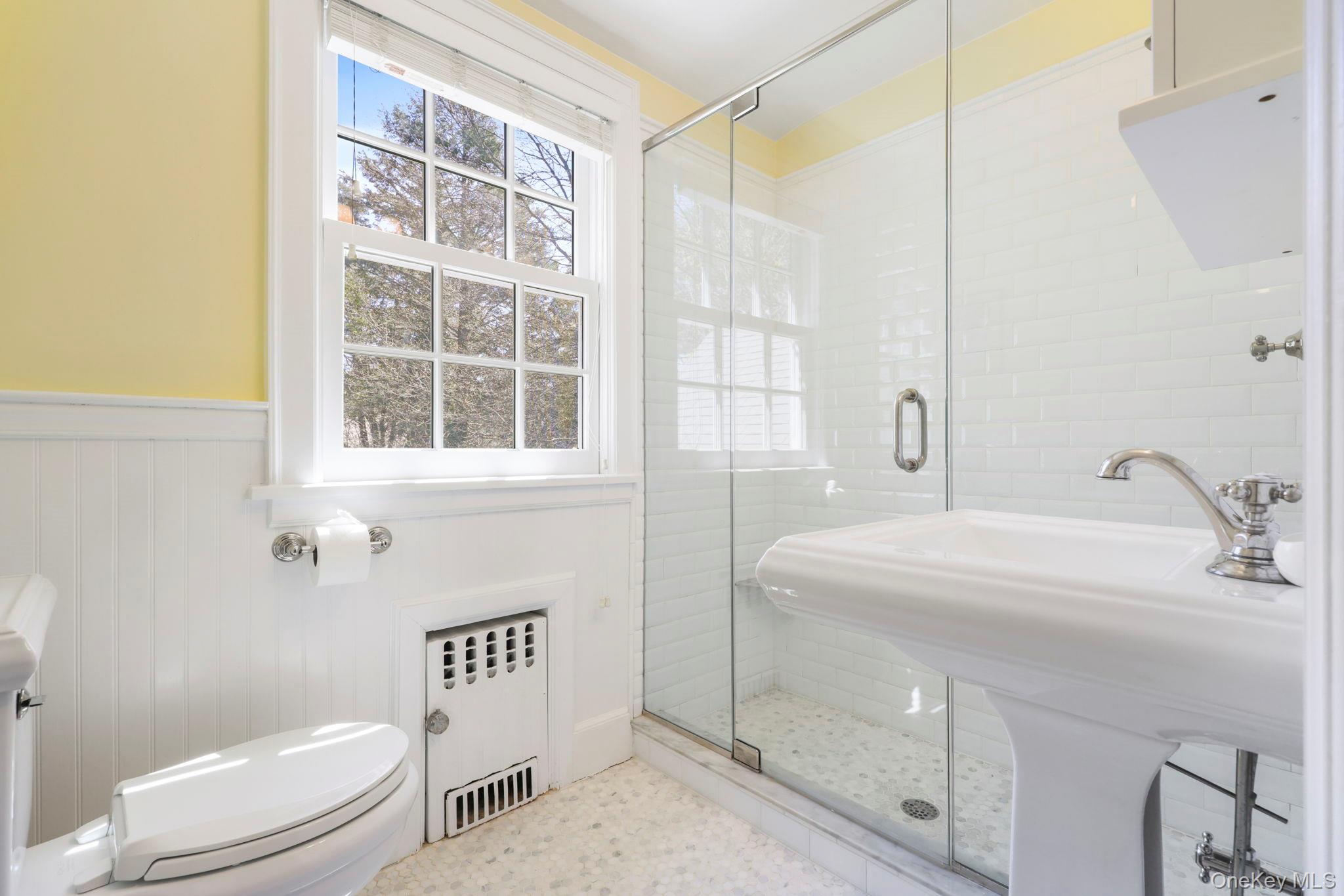 134 Brewster Road Scarsdale, NY 10583 - Photo 24 of 37 a bathroom with a sink a toilet and shower