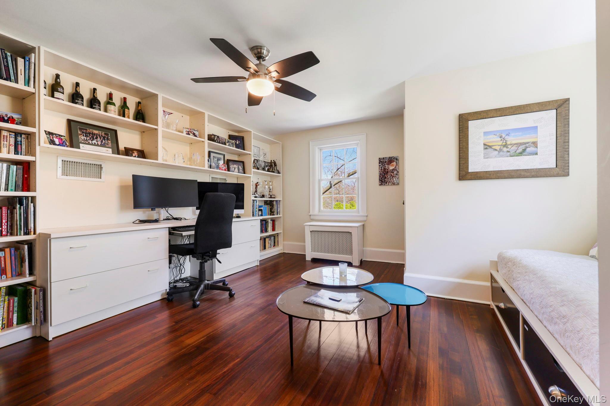134 Brewster Road Scarsdale, NY 10583 - Photo 25 of 37 a workspace with furniture wooden floor and a book shelf