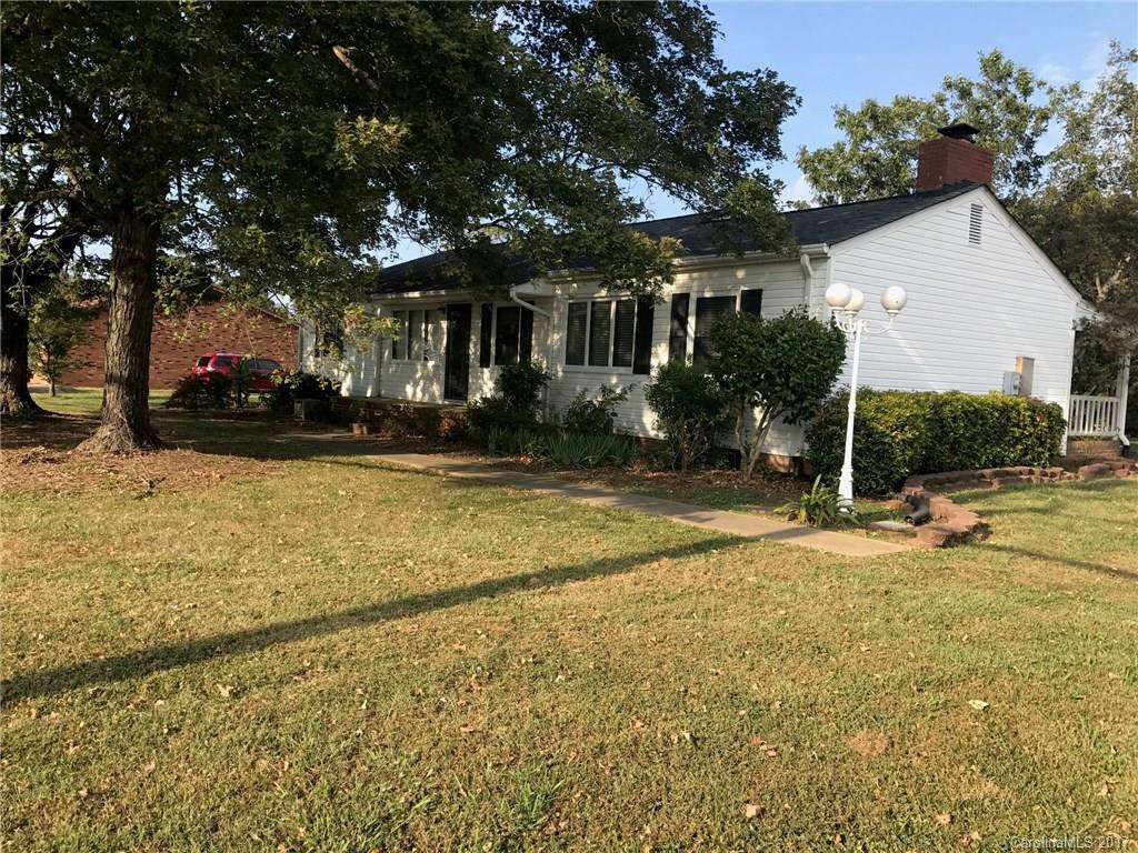 a view of a house with a yard and tree s