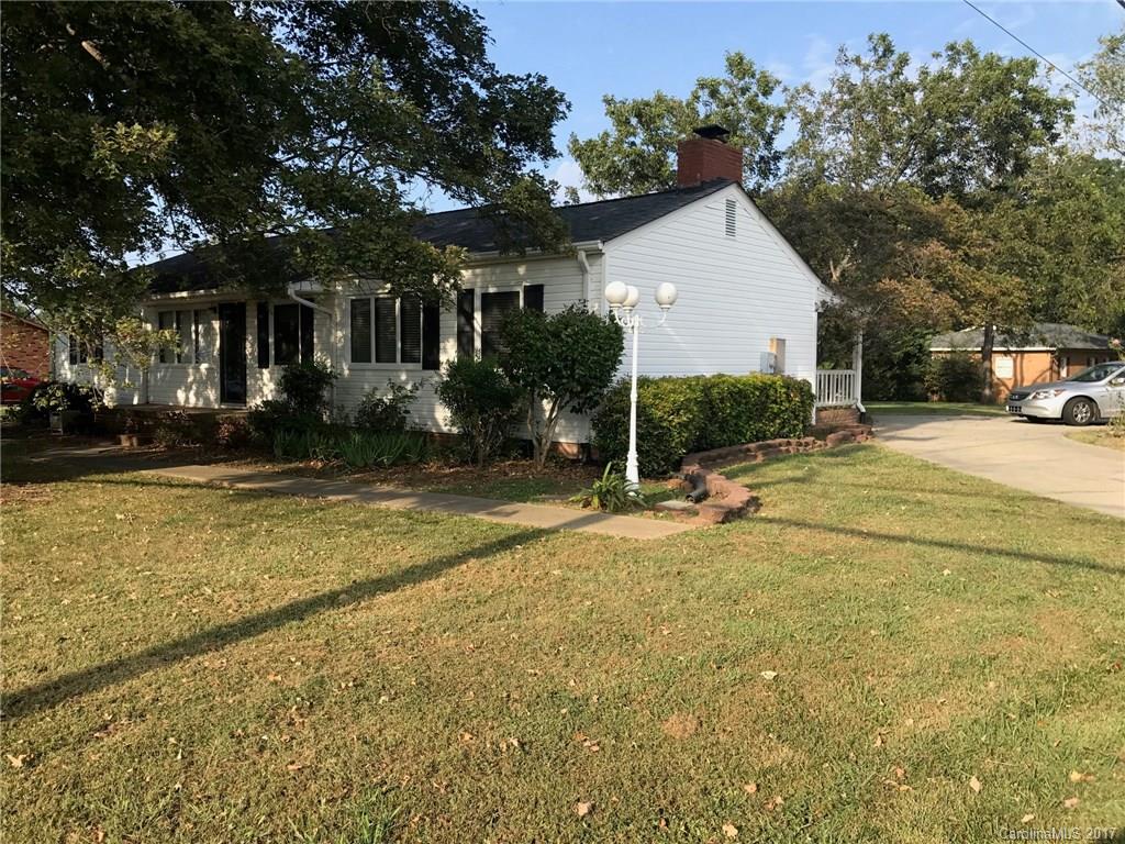 6561 Morehead Road Harrisburg, NC 28075 - Photo 2 of 24 a view of a white house with a yard and sitting area