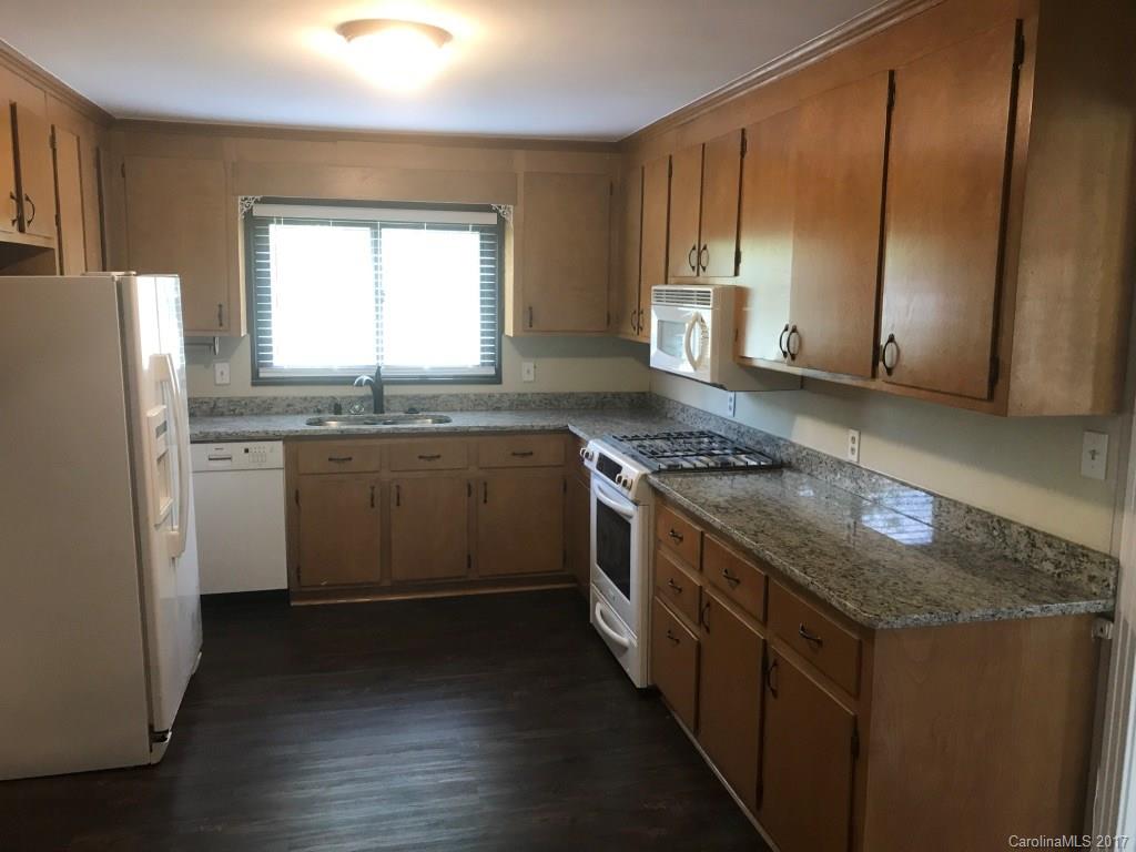 6561 Morehead Road Harrisburg, NC 28075 - Photo 11 of 24 a kitchen with stainless steel appliances granite countertop a stove a sink dishwasher and a refrigerator