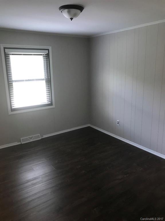 6561 Morehead Road Harrisburg, NC 28075 - Photo 13 of 24 an empty room with wooden floor and windows