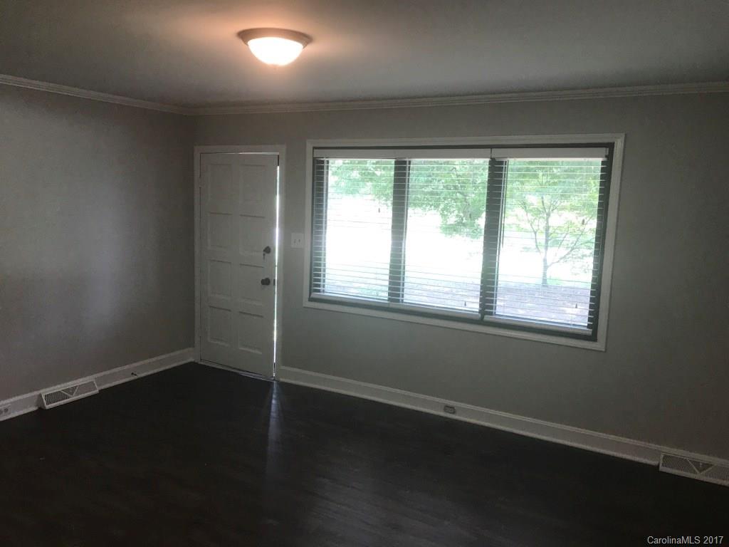 6561 Morehead Road Harrisburg, NC 28075 - Photo 14 of 24 a view of an empty room with wooden floor and a window