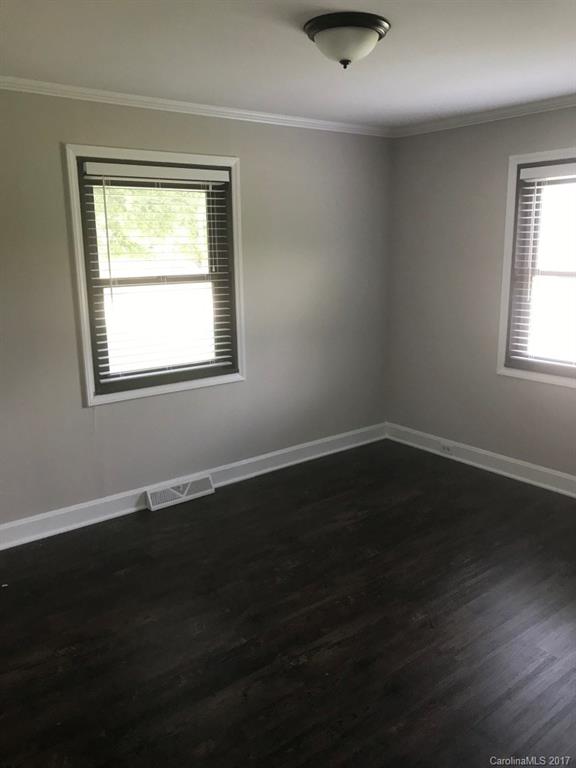 6561 Morehead Road Harrisburg, NC 28075 - Photo 17 of 24 a view of an empty room with wooden floor and a window