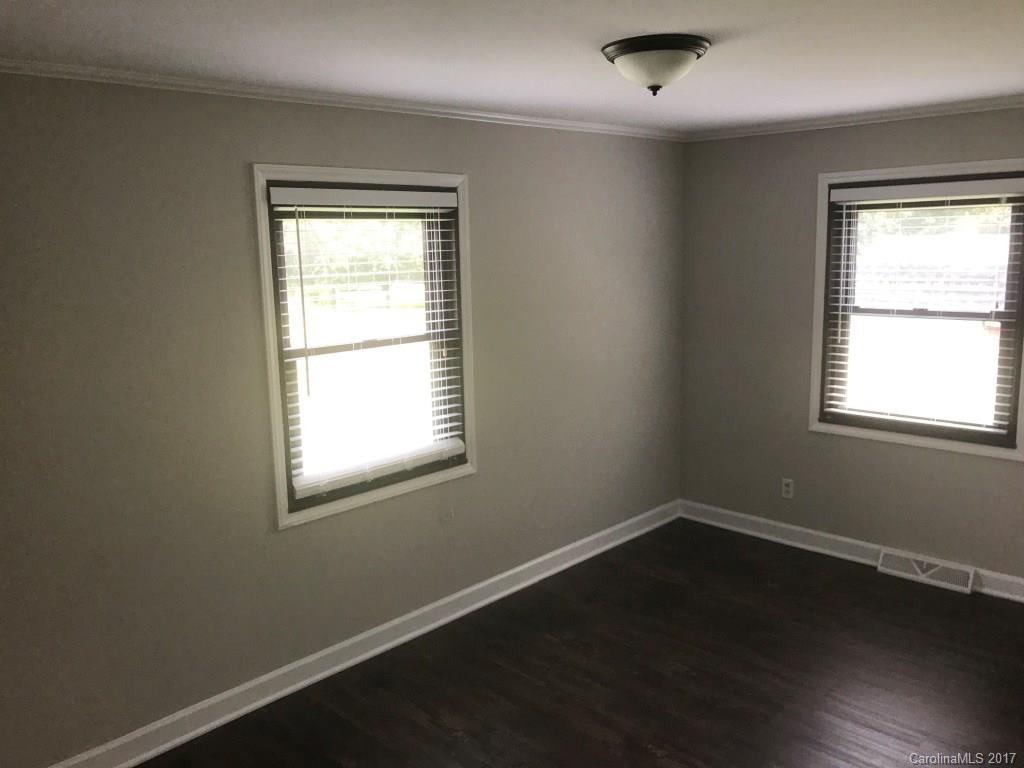 6561 Morehead Road Harrisburg, NC 28075 - Photo 18 of 24 a view of a room with wooden floor and windows