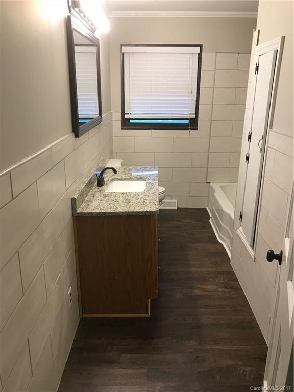 6561 Morehead Road Harrisburg, NC 28075 - Photo 19 of 24 a bathroom with sink mirror and vanity