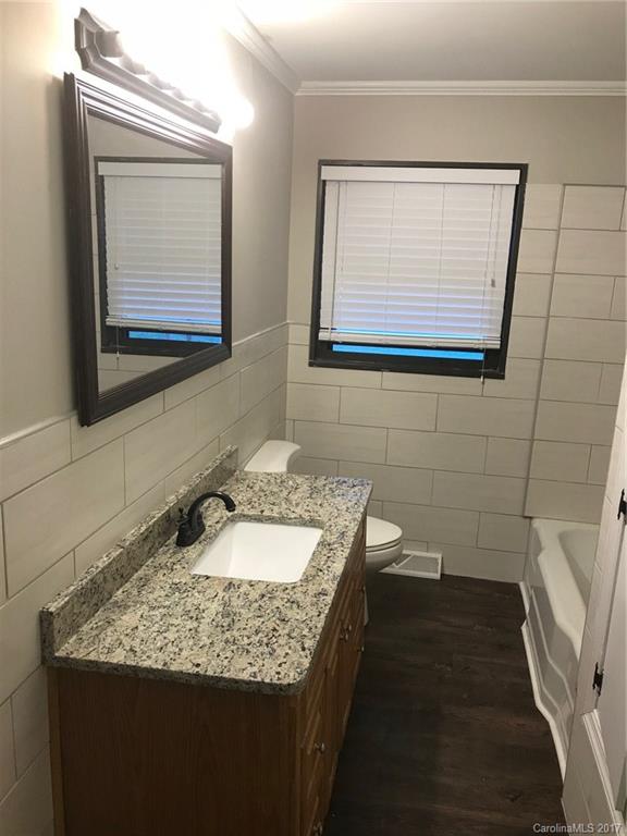 6561 Morehead Road Harrisburg, NC 28075 - Photo 20 of 24 a bathroom with a granite countertop sink and a mirror