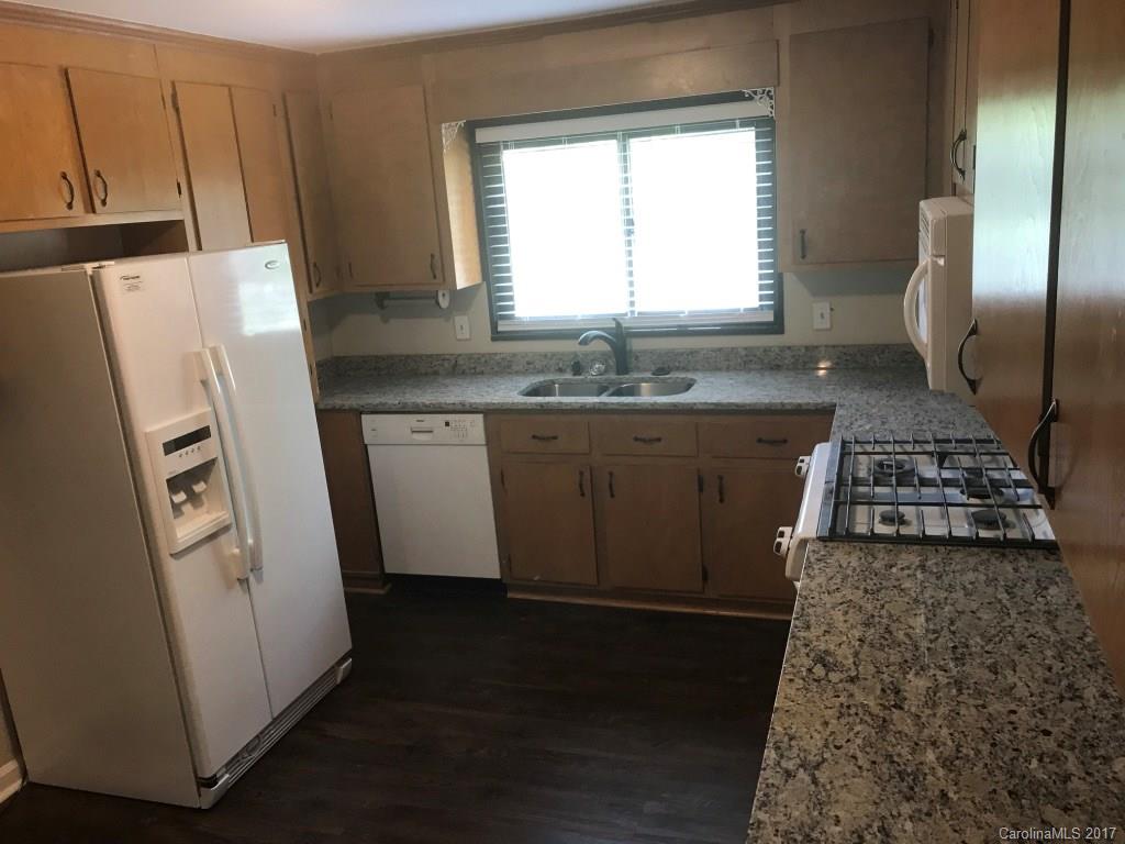 6561 Morehead Road Harrisburg, NC 28075 - Photo 7 of 24 a kitchen with a sink a refrigerator and a stove