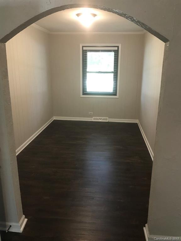 6561 Morehead Road Harrisburg, NC 28075 - Photo 9 of 24 an empty room with wooden floor and windows