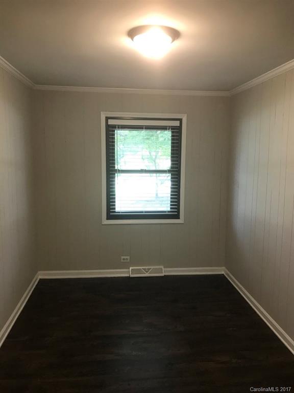 6561 Morehead Road Harrisburg, NC 28075 - Photo 10 of 24 an empty room with wooden floor and windows