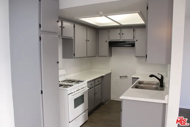 a kitchen with stainless steel appliances a sink and cabinets