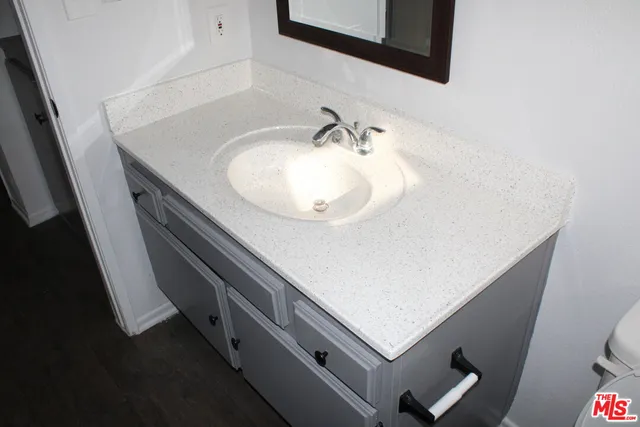 a bathroom with a sink a mirror and vanity