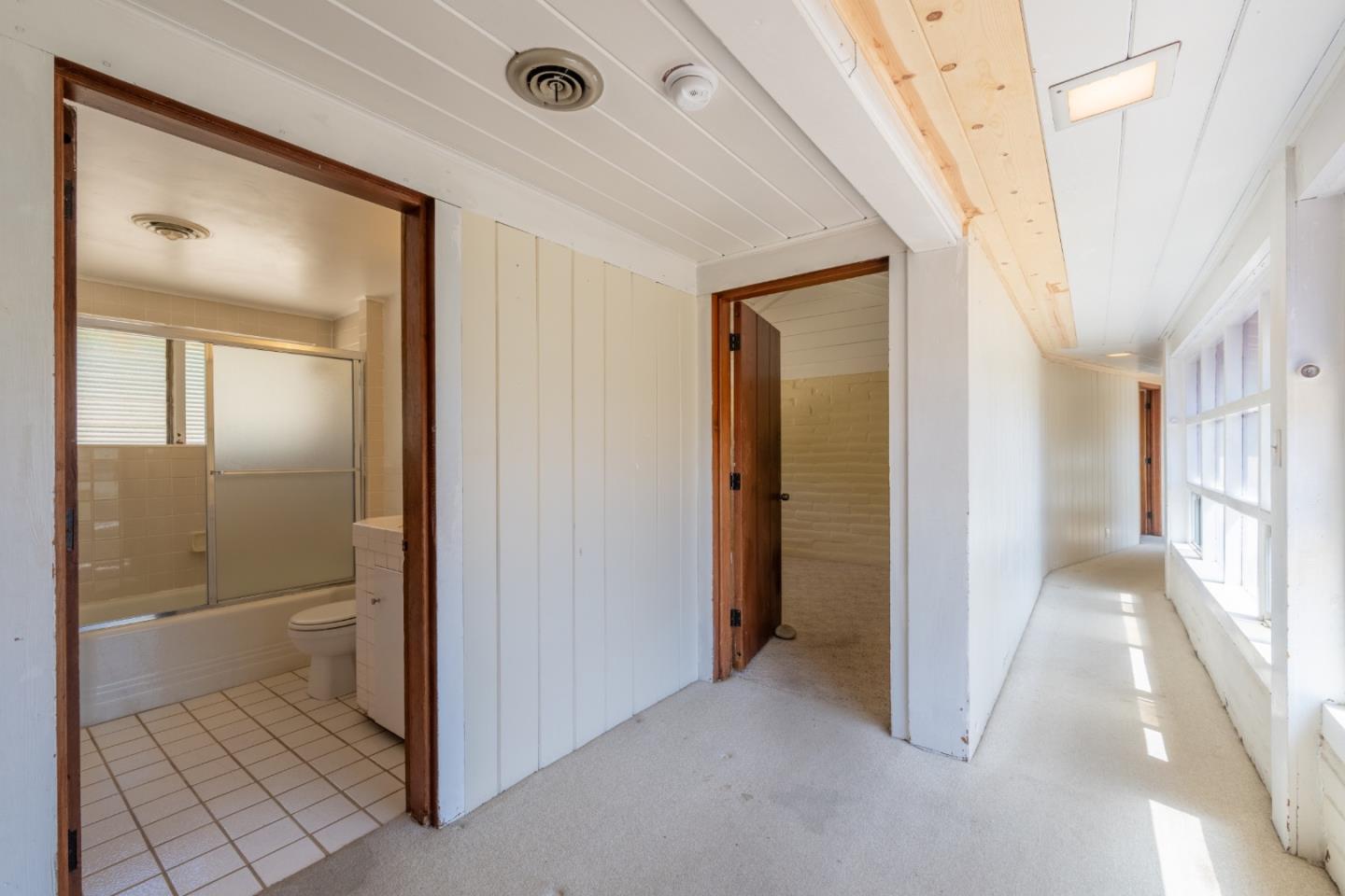 72 Los Laureles Grade Road Carmel Valley, CA 93924 - Photo 20 of 43 a view of a hallway with a livingroom and a bathroom with a bathtub